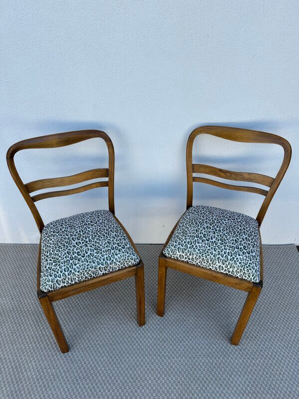 Élégantes chaises des années 50 dont l’assise a été entièrement rénovée : mousse et tissu neufs. L’assise repose sur des ressorts. Chaises art déco en bois massif, très stable.